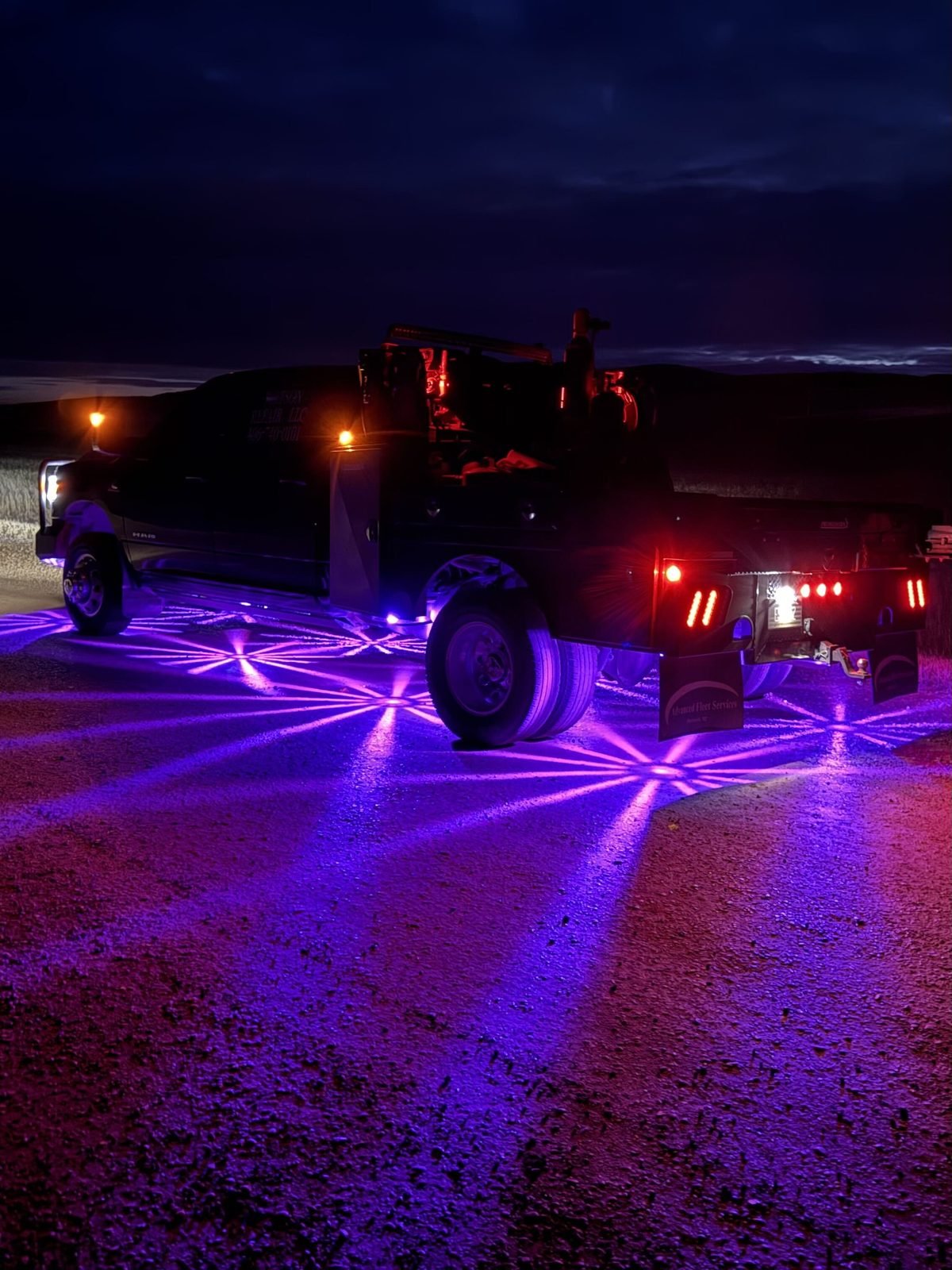 Watson Repair's service truck lit up at night, ready for a call
