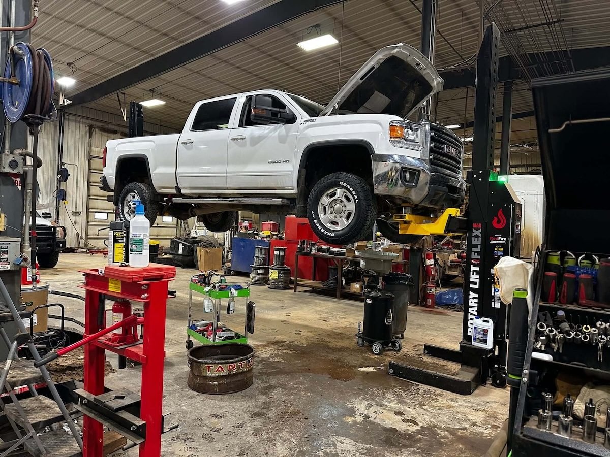 Pickup truck raised on the lift for service